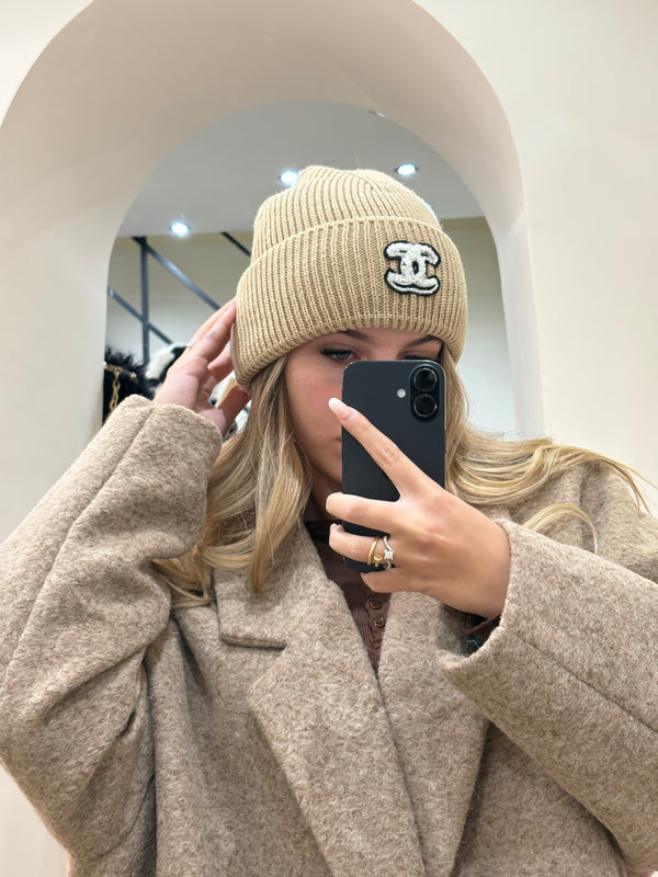Cappello Chanel beige con logo nero e ricami bianchi