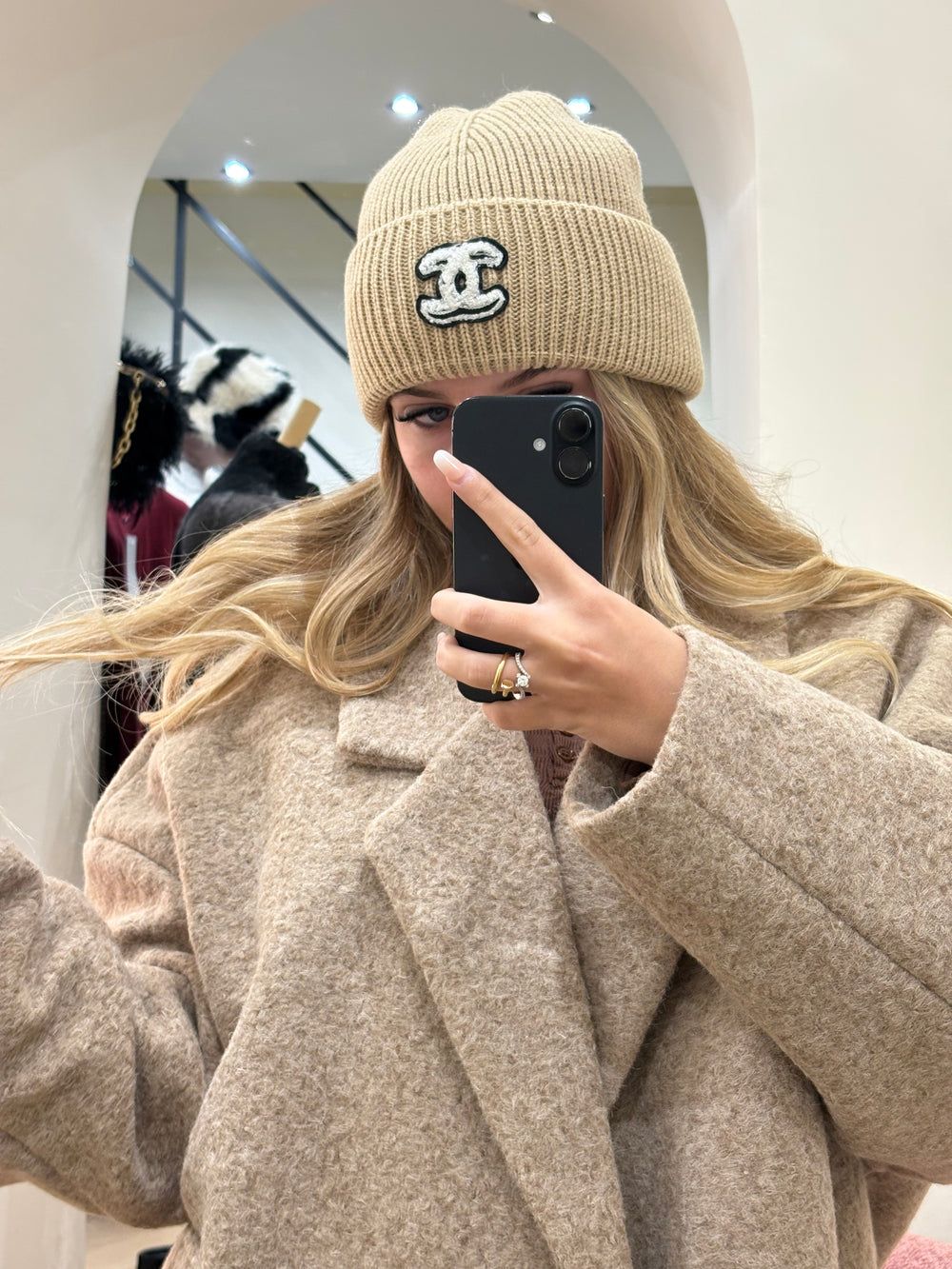 Cappello Chanel beige con logo nero e ricami bianchi